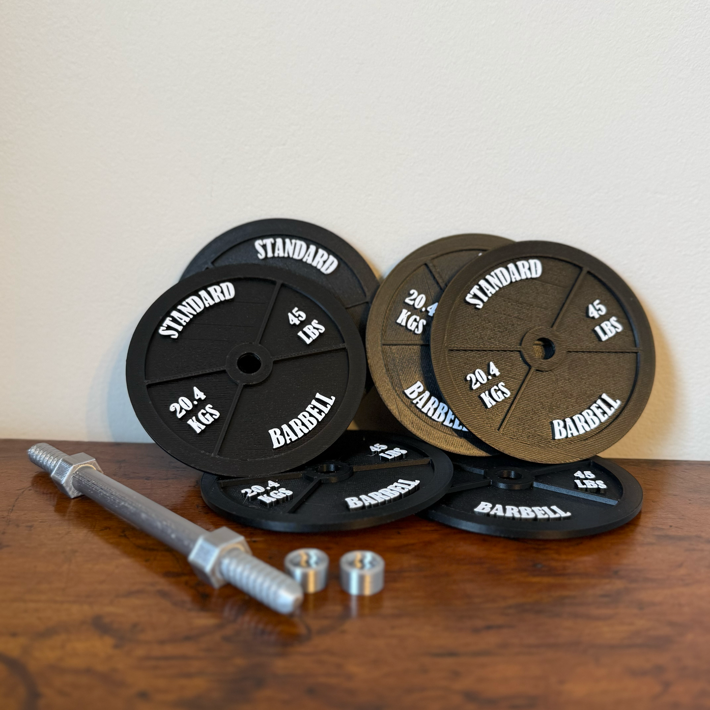 Realistic black dumbbell shaped coaster disassembled with parts bars and screw bolts and individual coasters for gym lovers, 3D printed fitness-themed drink coaster, masculine home gym decor, weight plate desk accessory for bodybuilders.