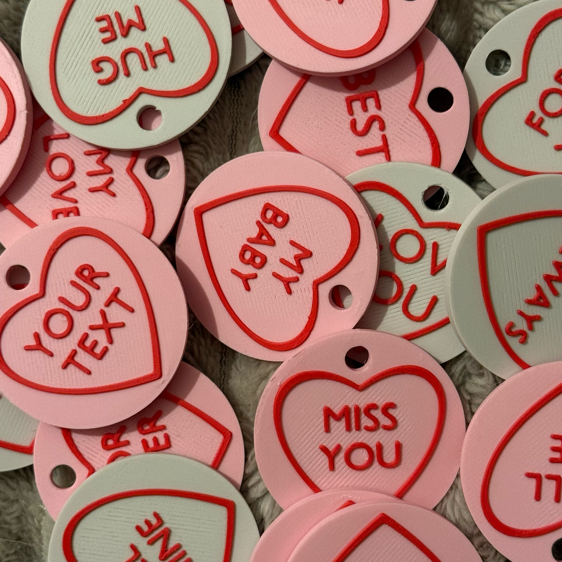 Heart-shaped tags with various messages on a textured surface