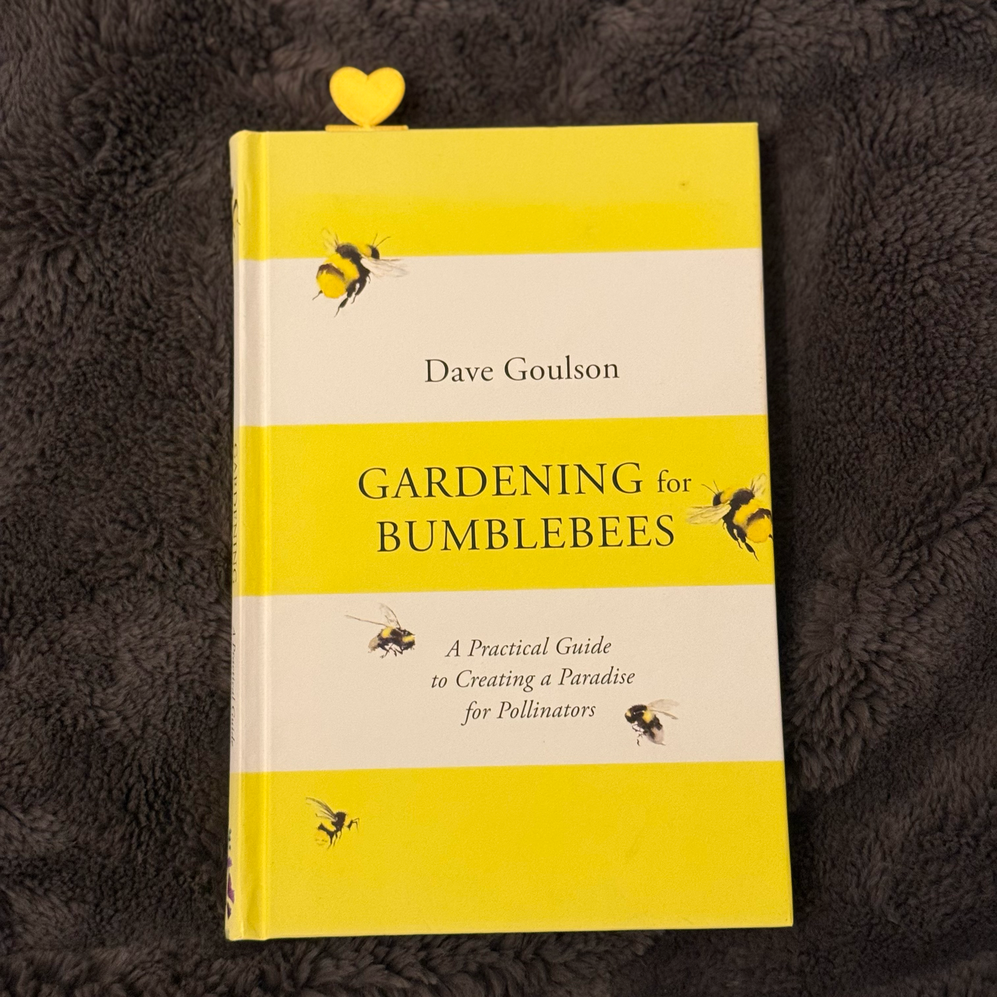 Book titled 'Gardening for Bumblebees' by Dave Goulson on a textured dark surface.