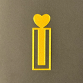 Decorative gold bookmark with heart designs on a fluffy soft surface